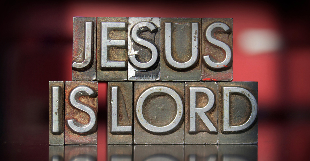 Abstract hues of red background with Jesus Is Lord written across it.