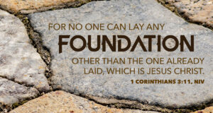 Rocked wall background with the words of 1 Corinthians 3:11 NIV in the foreground.